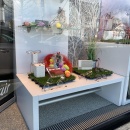 Colorful Easter eggs decorate the shop window of an optician and hearing care...