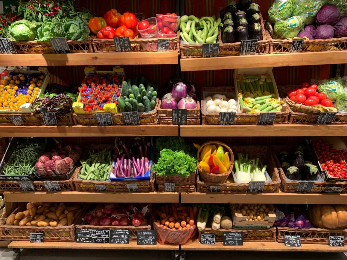 A shelf with vegetables and fruits in a grocery store...
