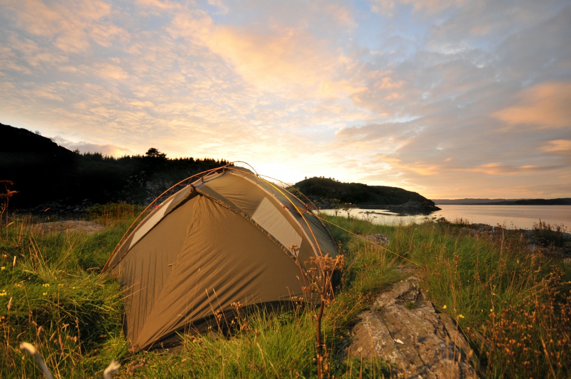 A tent in front of a lake
