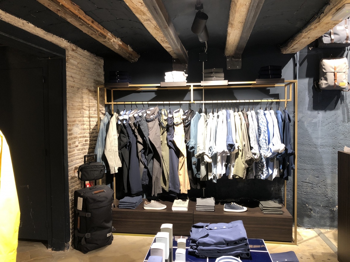 Presentation of clothing at the back of the store.