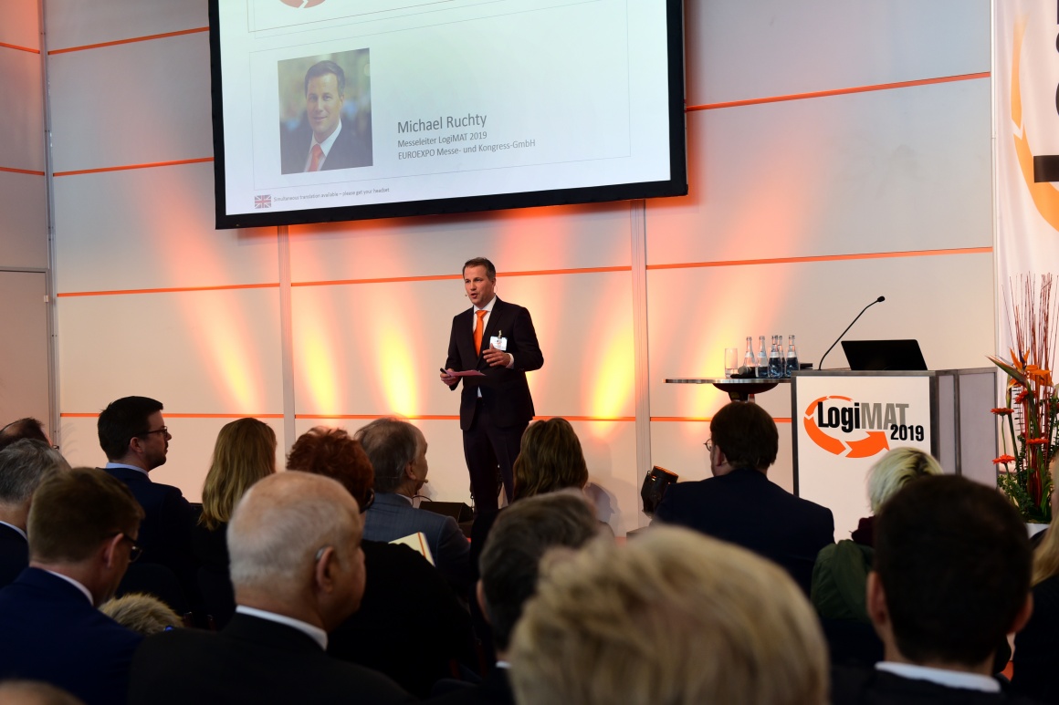 Man speaks on a stage at LogiMAT