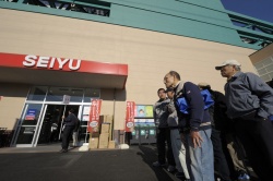 Customers wait in line for the opening of a Seiyu GK supermarket in Tokyo....