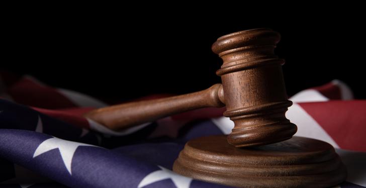 Judge’s gavel on an American flag; copyright: panthermedia.net/MicEnin...