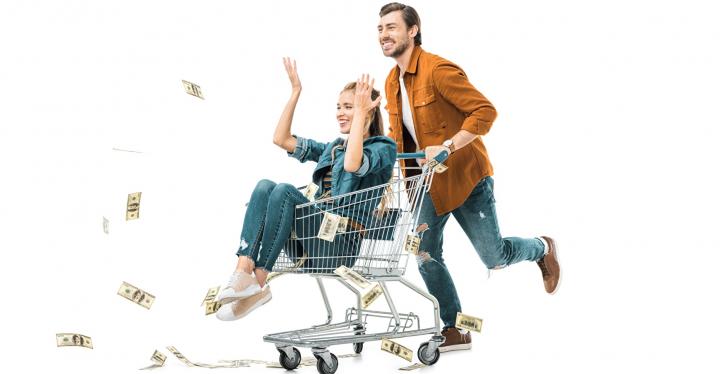 Woman sitting in a shopping cart driven by a man, throwing bank notes away;...