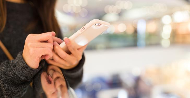 A woman holding a smartphone in her hands