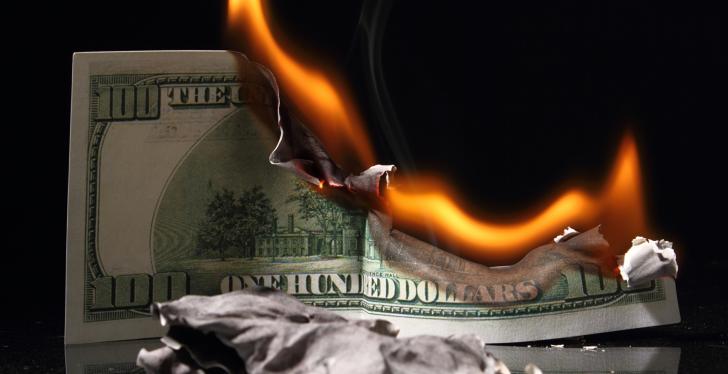 A burning dollar note; copyright: PantherMedia/v.gi...