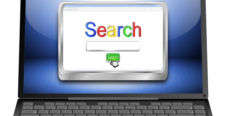 On the screen of a laptop are written the words Search...