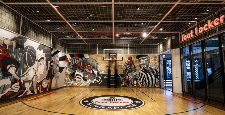 A basketball court with murals on the wall