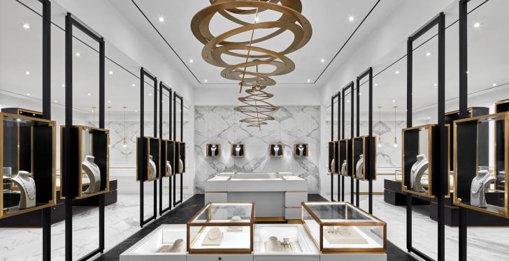 A jewelry store with white walls, golden decoration and black showcases...