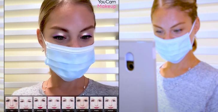 A woman with a face mask using a virtual makeup try on tool...