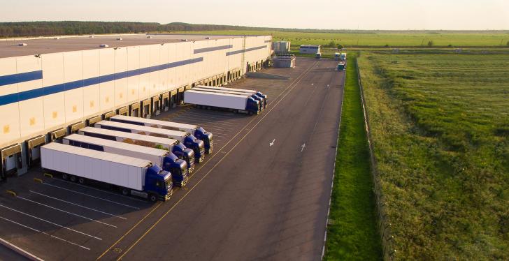 A large greenfield shipping center with trucks