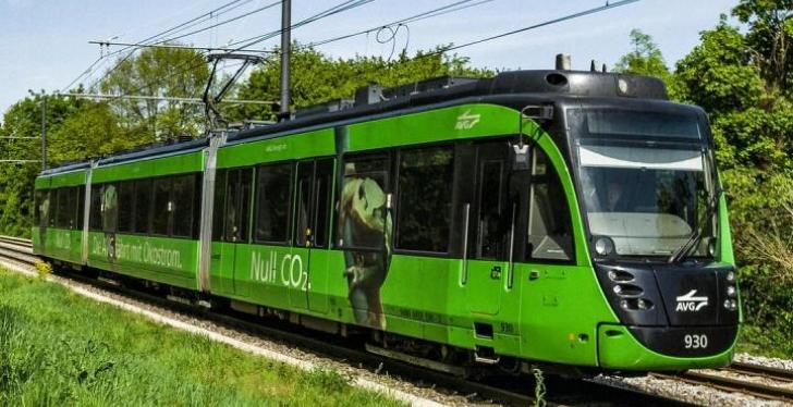 A green tram of the Albtal-Verkehrs-Gesellschaft in the countryside...