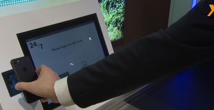 Person holds smartphone at checkout terminal