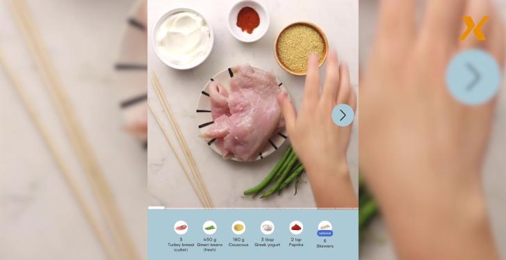 Screenshot of a video where ingredients to a dish are placed on a table;...