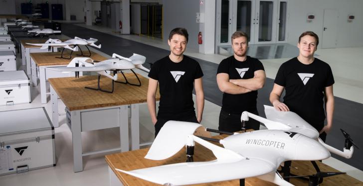 The three founders of the company Wingcopter are standing in their production...