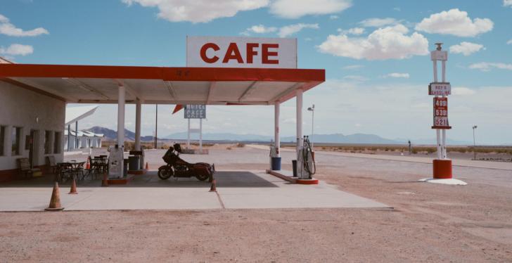 A gas station in the middle of a desert in the United States with the word...