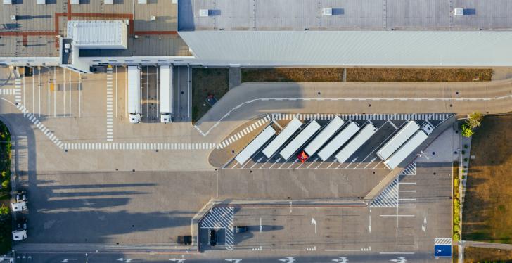 A birds eye view of a warehouse with trucks