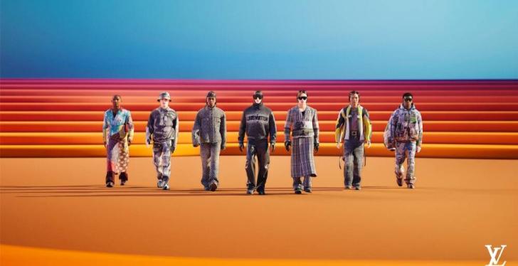 Seven people in fancy clothes in front of an artificial red-orange background...