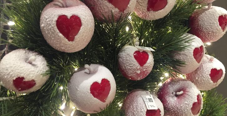 White Christmas baubles with a heart on a Christmas tree....