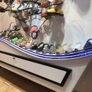 A sideboard in a store with shoes on it