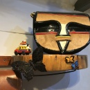 An artistic handbag on a wooden shelf