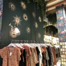 Coat rack in front of a wall with various decorative elements...