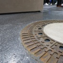 A manhole cover recessed into the floor