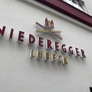 The Niederegger logo adorns the exterior façade of the building and refers to...