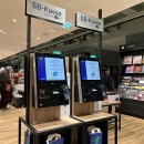 Self-service checkouts with large screens.