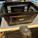 Empty packing table with scanning station, shopping cart being prepared to...