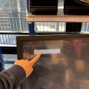 Hand taps on “Small package” on the screen to select the appropriate...