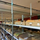 Shelves with goods and active pick-by-light system, blue light indicates the...