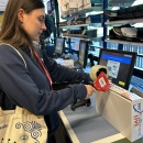 person closes the shipping carton securely with packing tape at the packing...