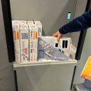 Packed and labeled parcels are placed in a shipping trolley with other parcels....