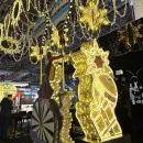 Large golden light decoration with stars, gift shapes and a bicycle....