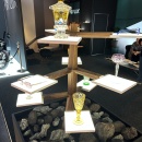 Multi-level display with illuminated pedestals on which glass vessels and...