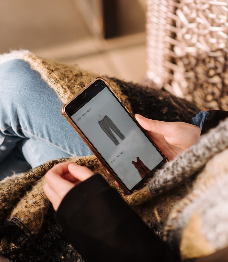 A person looking at clothes on a mobile phone