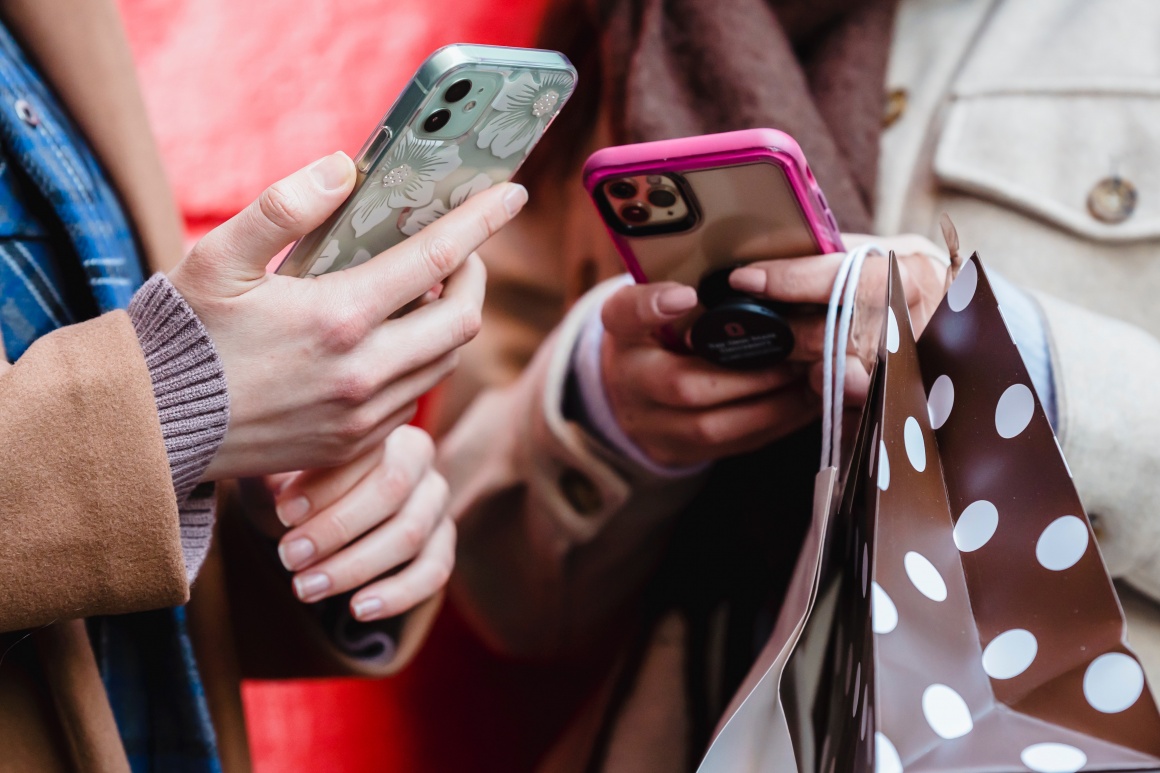 Two people holding their smartphones