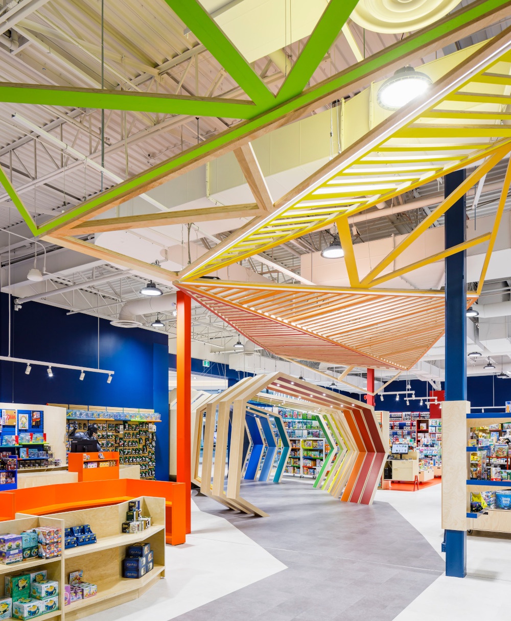 A game store with colorful shop design and rainbow-colored wooden arches as an...