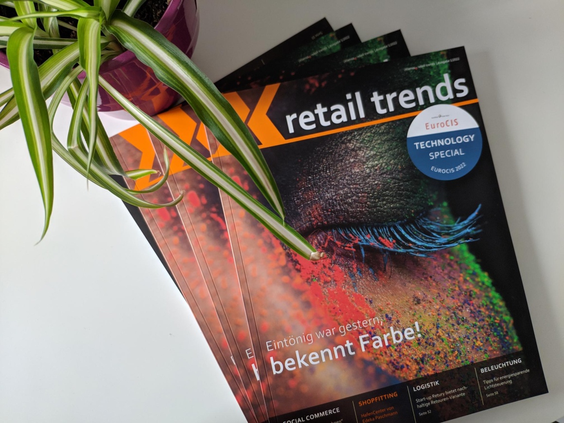 New retail trends magazines on a white background. Top left a green plant in a...