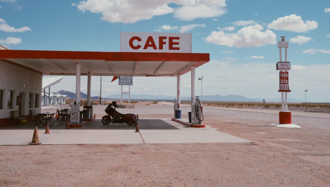 A gas station in the middle of a desert in the United States with the word...