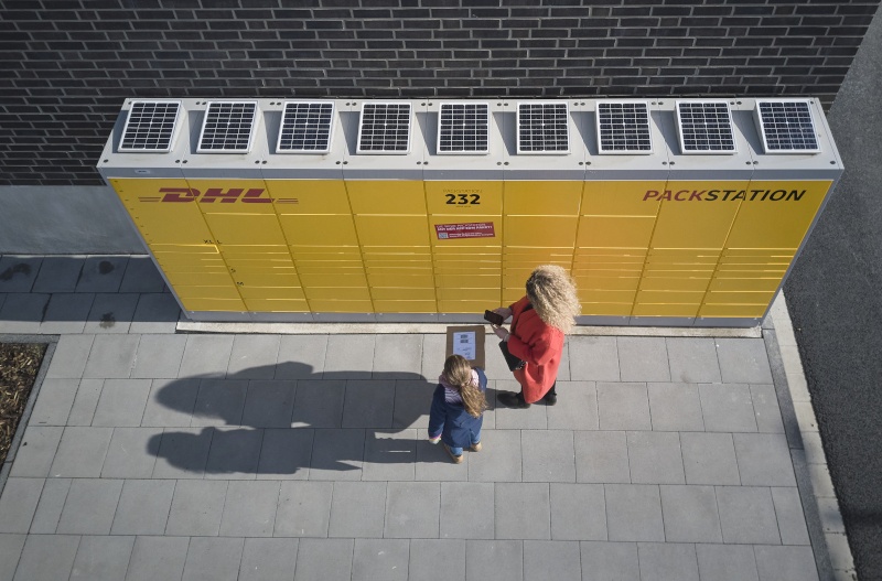 A DHL packing station with solar panels on the roof photographed from above, in...