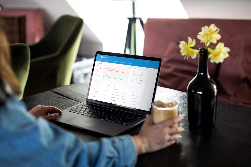 A person works on a laptop in the living room, with access control information...