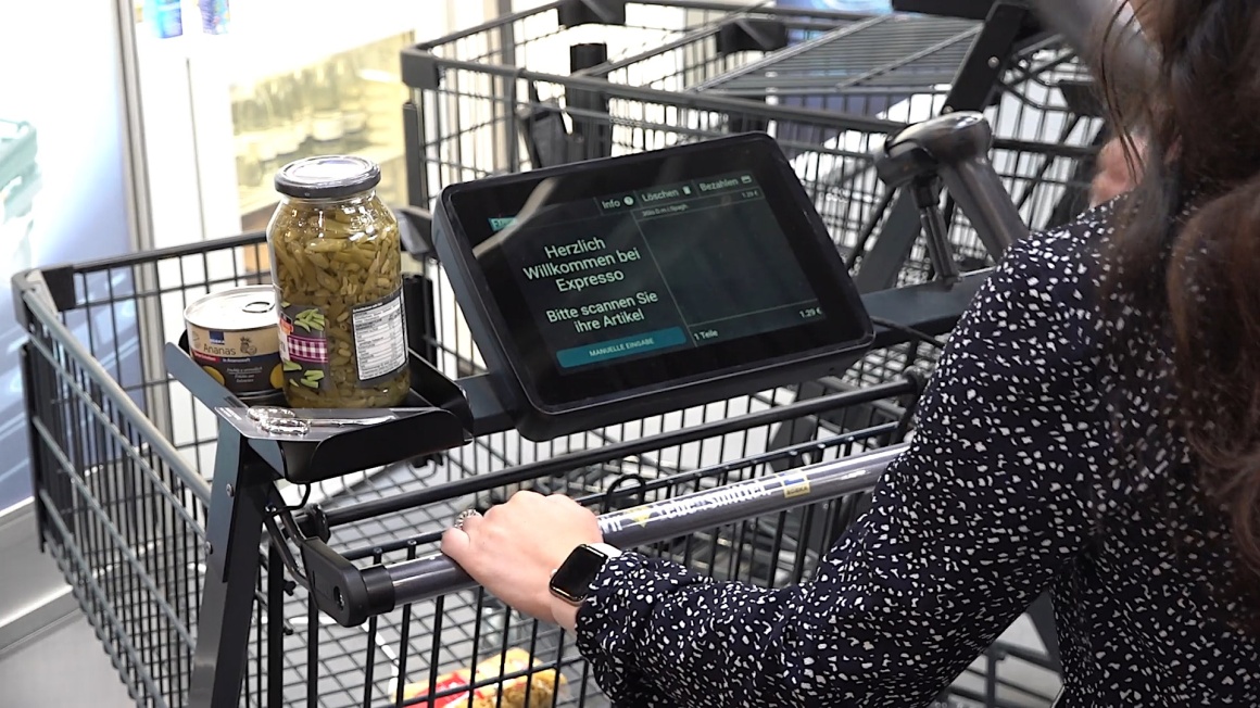 A person uses the Expresso SmartShopper at EuroCIS 2022...