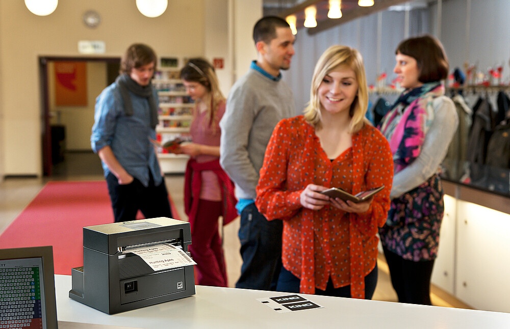 Woman at mobile ticketing printer