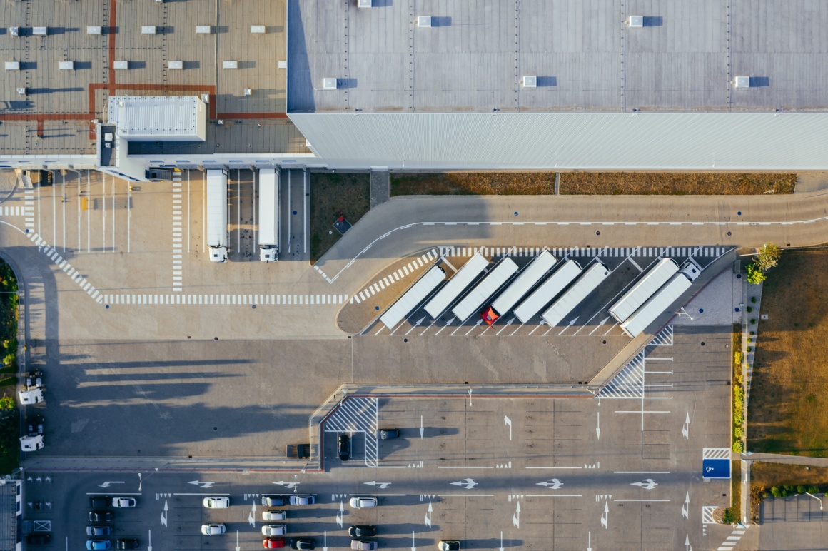 A birds eye view of a warehouse with trucks