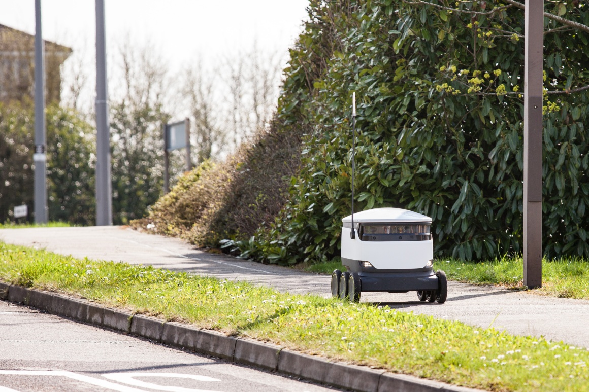 A self-driving robot drives on a pavement