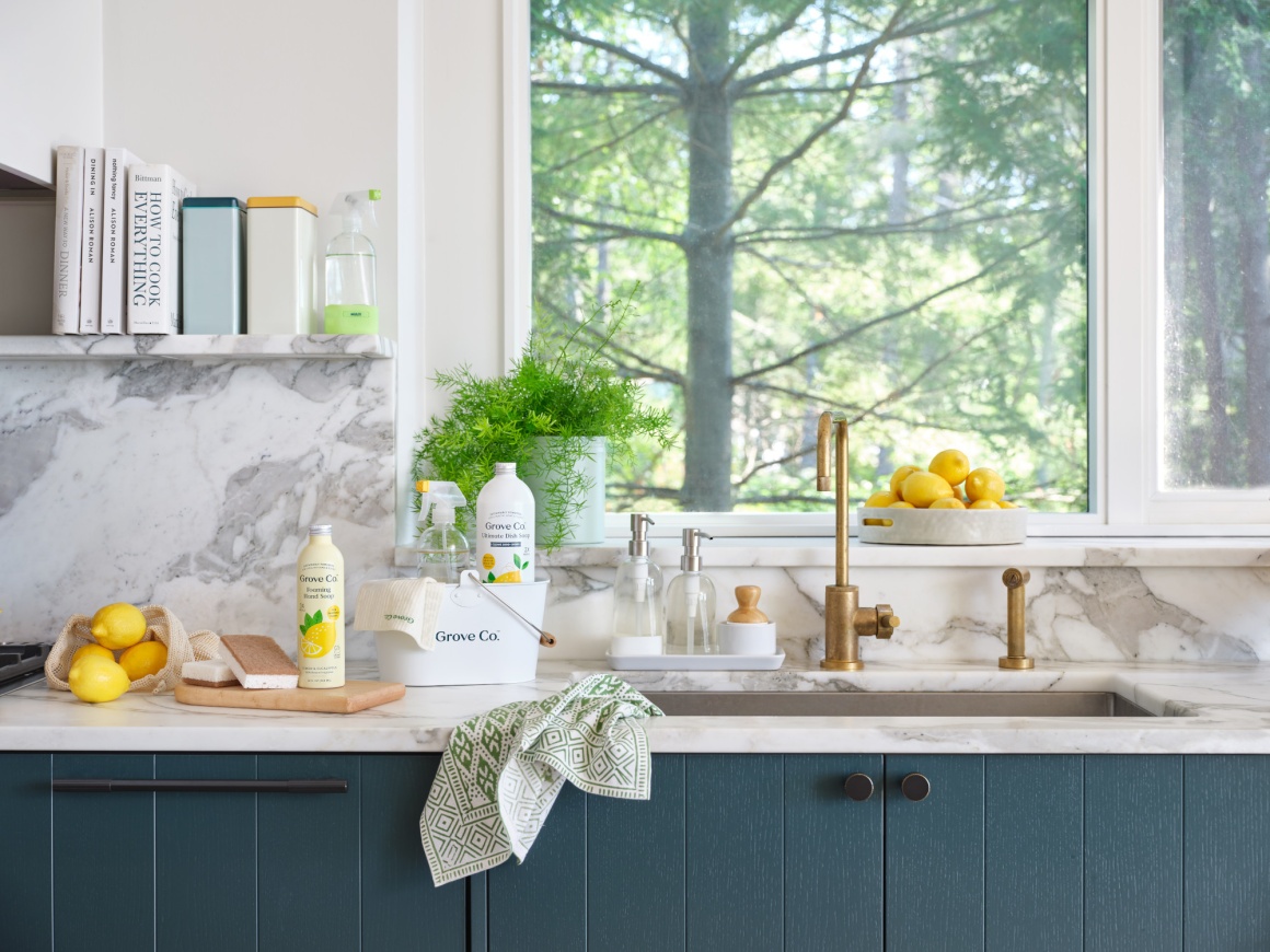 A white kitchen with various cleaning agents