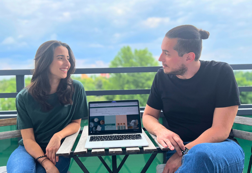 A woman and a man sitting at a table on a balcony