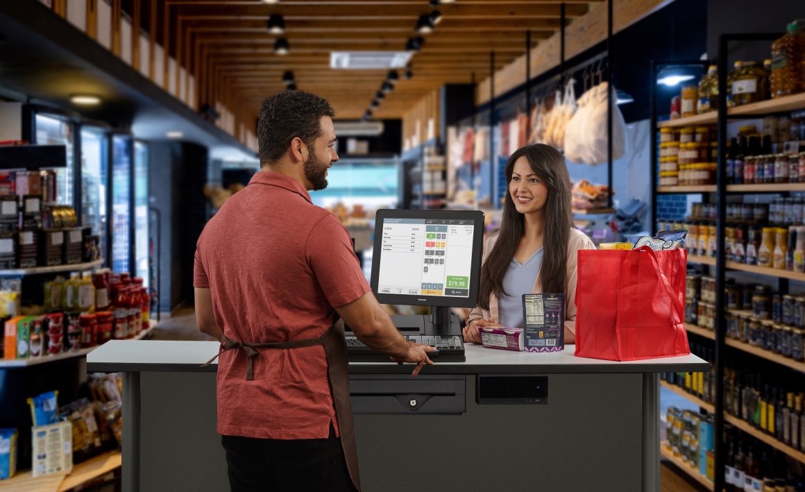 Two people at a sales counter in a retail shop